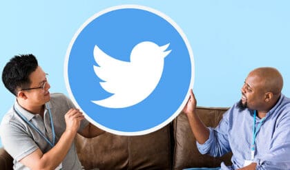 Diverse men holding twitter icon sitting on couch